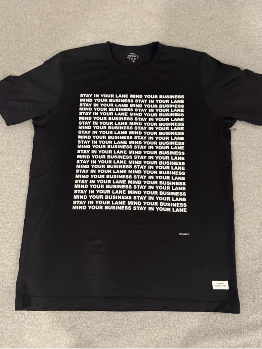 Stampd Black Tee with White Repeated 'Stay In Your Lane' Print